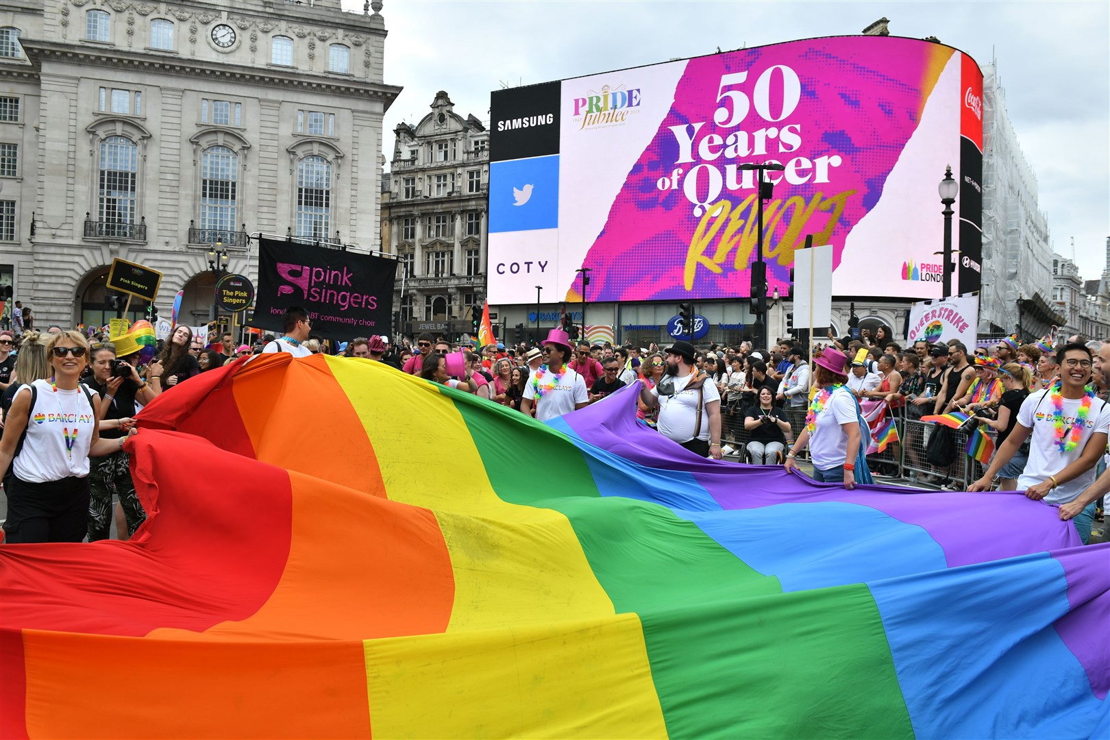 Members of the public watch during the Pride in London Parade in central London in 2019 (Dominic Lipinsky/PA)