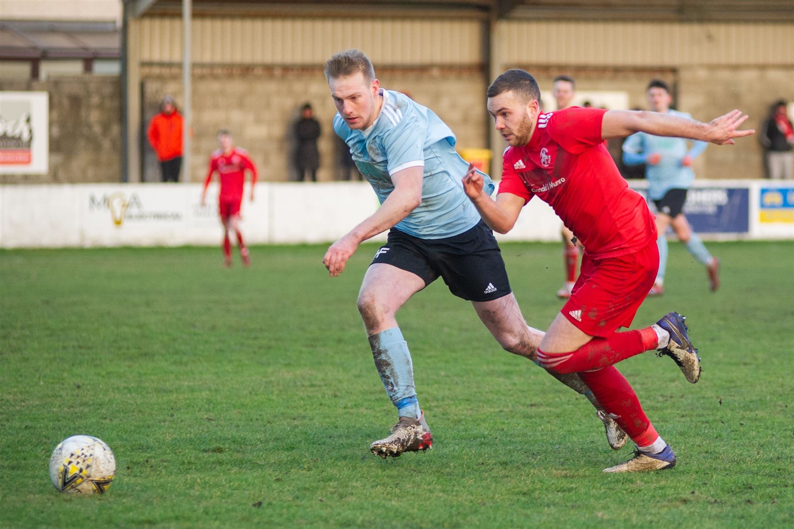 Deveronvale's Aaron Hamilton and Lossiemouth's Ryan Stuart chase down the ball. Picture: Daniel Forsyth..