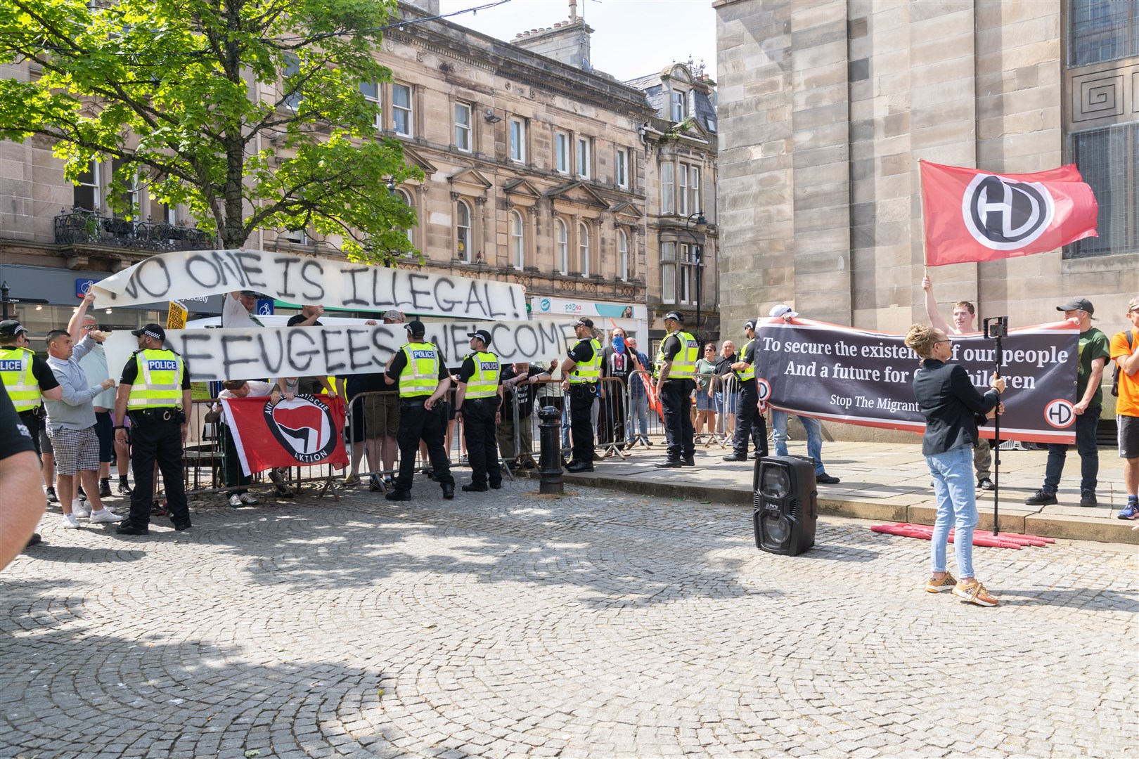 Members of the public gather outside the St Giles Centre in Elgin where the Moray Trades Union Council (MTUC) held a vigil alongside a far-right rally. Picture: Beth Taylor
