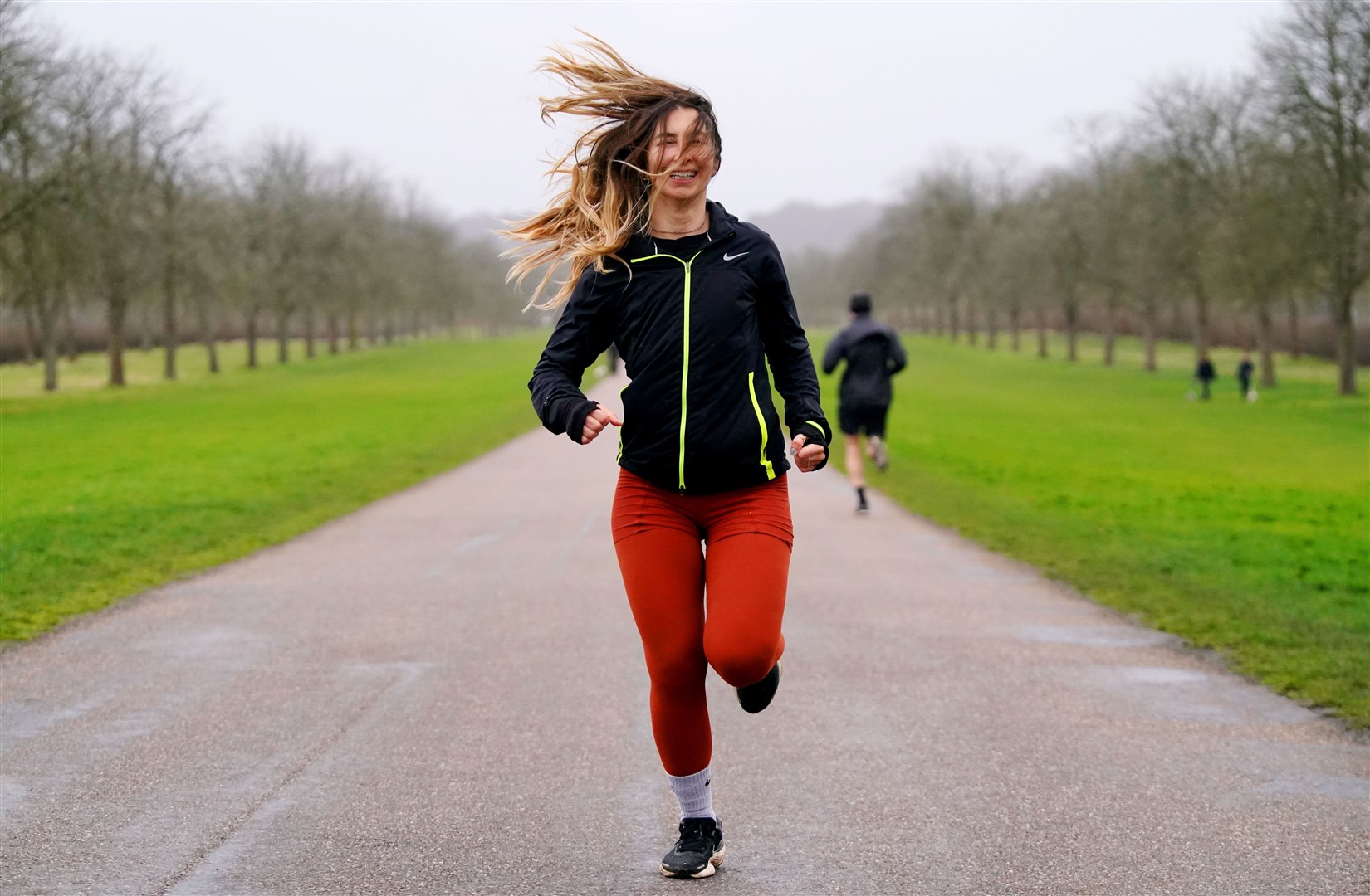 Beste Onal, from Richmond, has her hair swept across her face by the wind as she runs along the Long Walk in Windsor Great Park in February (Jonathan Brady/PA)