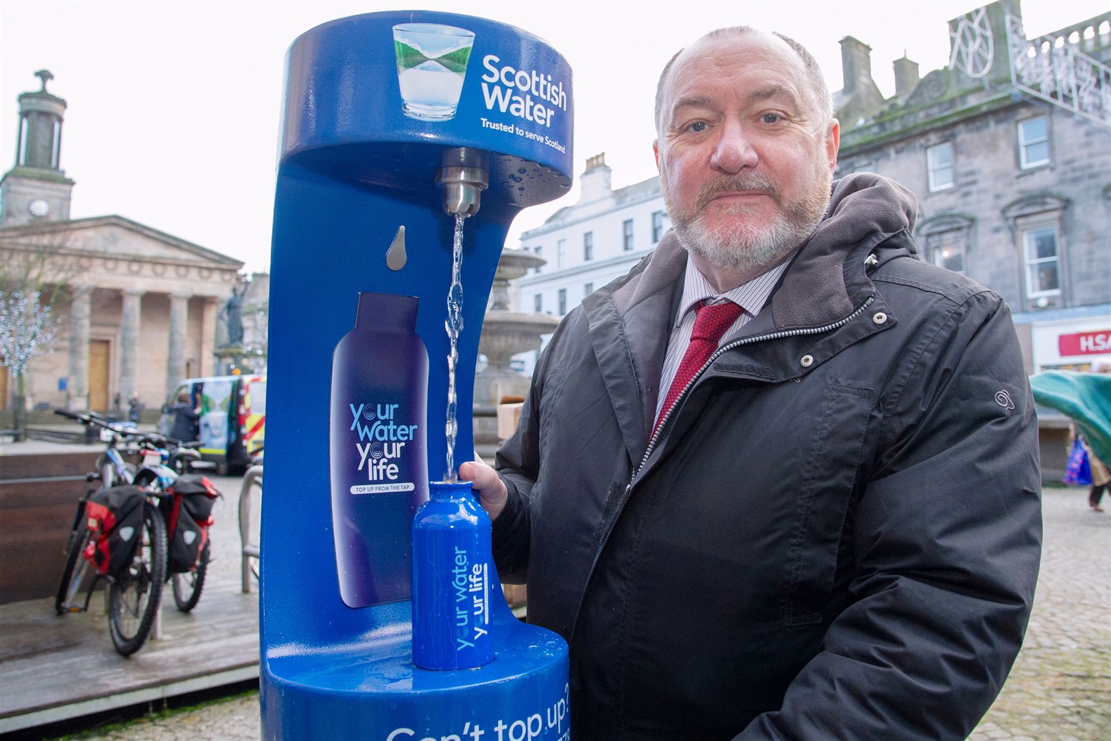 Councillor John Divers refills from the new tap at the Plainstones in Elgin. Picture: Daniel Forsyth.