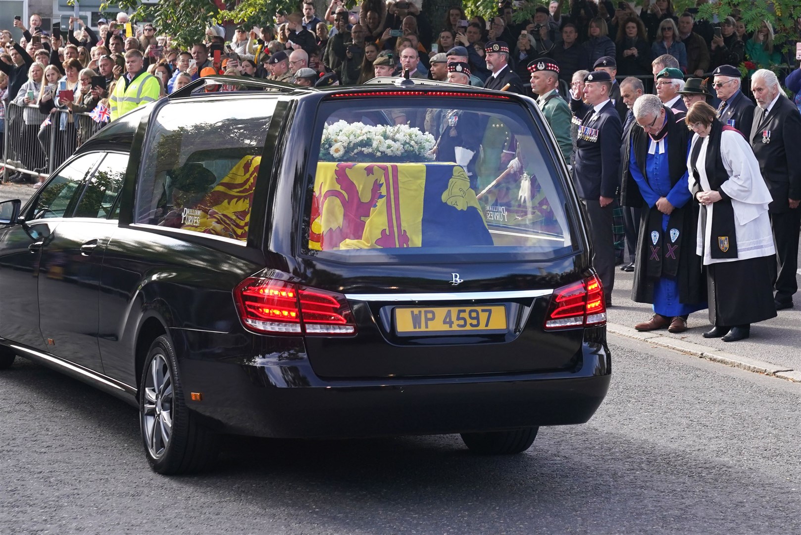 The hearse carrying the Queen’s coffin passes through Ballater. Andrew Milligan/PA