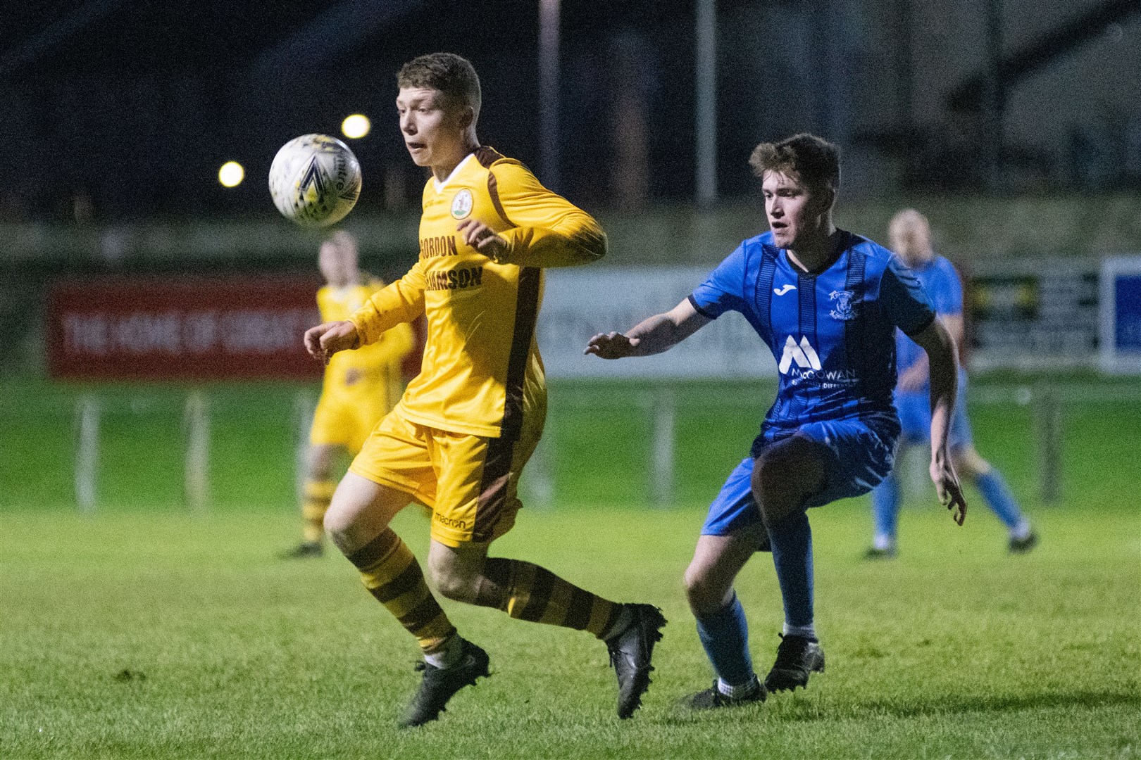 Forres Mechanics' Craig Mackenzie is tracked by Strathspey's Owen Paterson...Forres Mechanics FC (8) vs Strathspey Thistle FC (1) - Highland Football League 22/23 - Mosset Park, Forres 07/01/23...Picture: Daniel Forsyth..