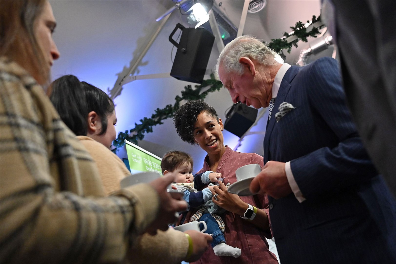Charles meets Little Haven’s Jess Rodewald and her seven-month-old baby Matthew, during a reception with Christian Communities at King’s House (PA)
