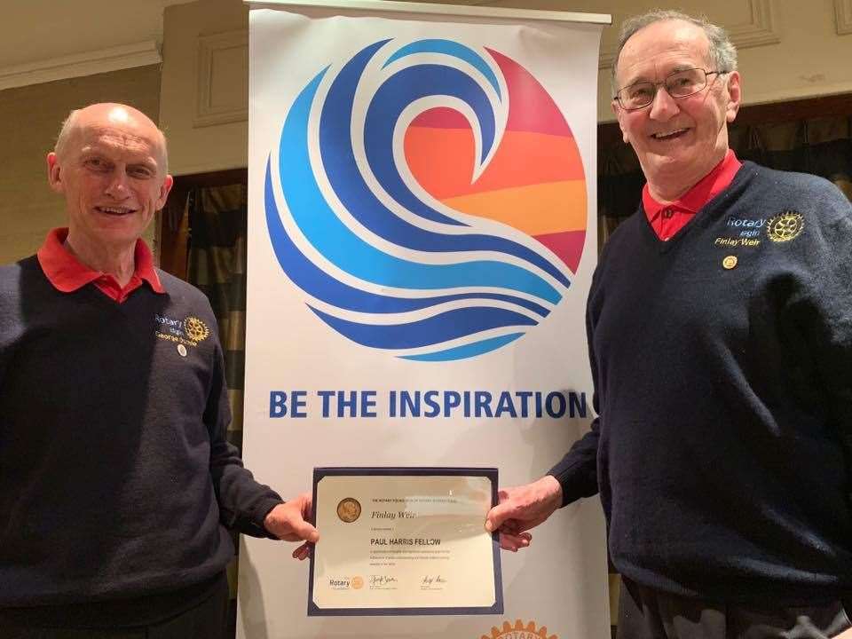Elgin Rotary President George Duthie presents Finlay Weir (right) with the Paul Harris Fellow award.