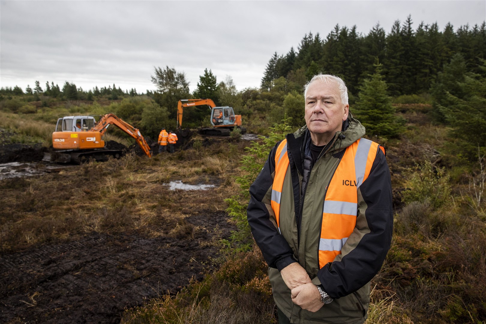 Jon Hill, of the Independent Commission for the Location of Victims’ Remains, stands besides excavators at Bragan bog near Emyvale in Co Monaghan (PA)