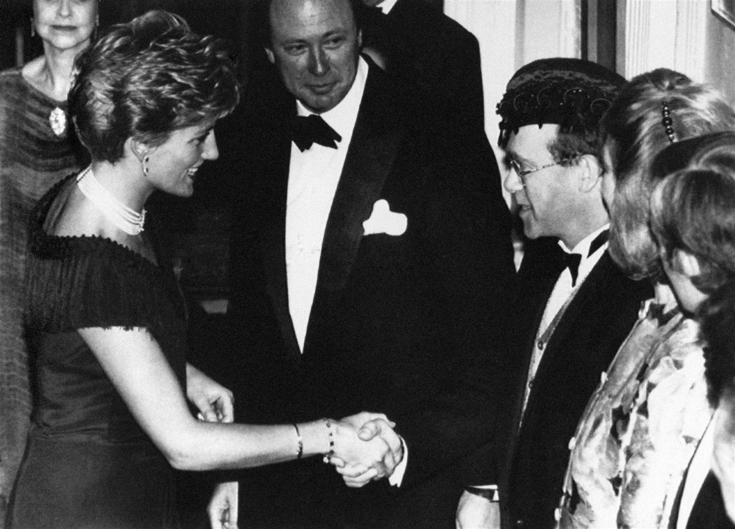 The Princess of Wales shakes hands with Elton John at the charity premiere of the musical Tango Argentino in London in 1991 (PA)