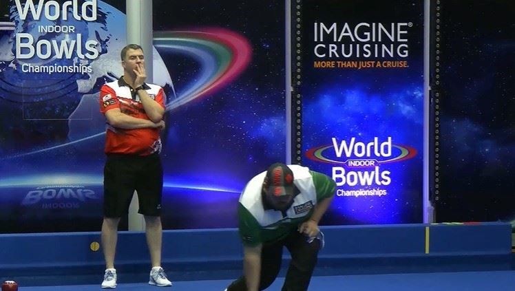 Michael Stepney (left) watches play in his quarter-final. Photo: World Indoor Bowls Facebook.