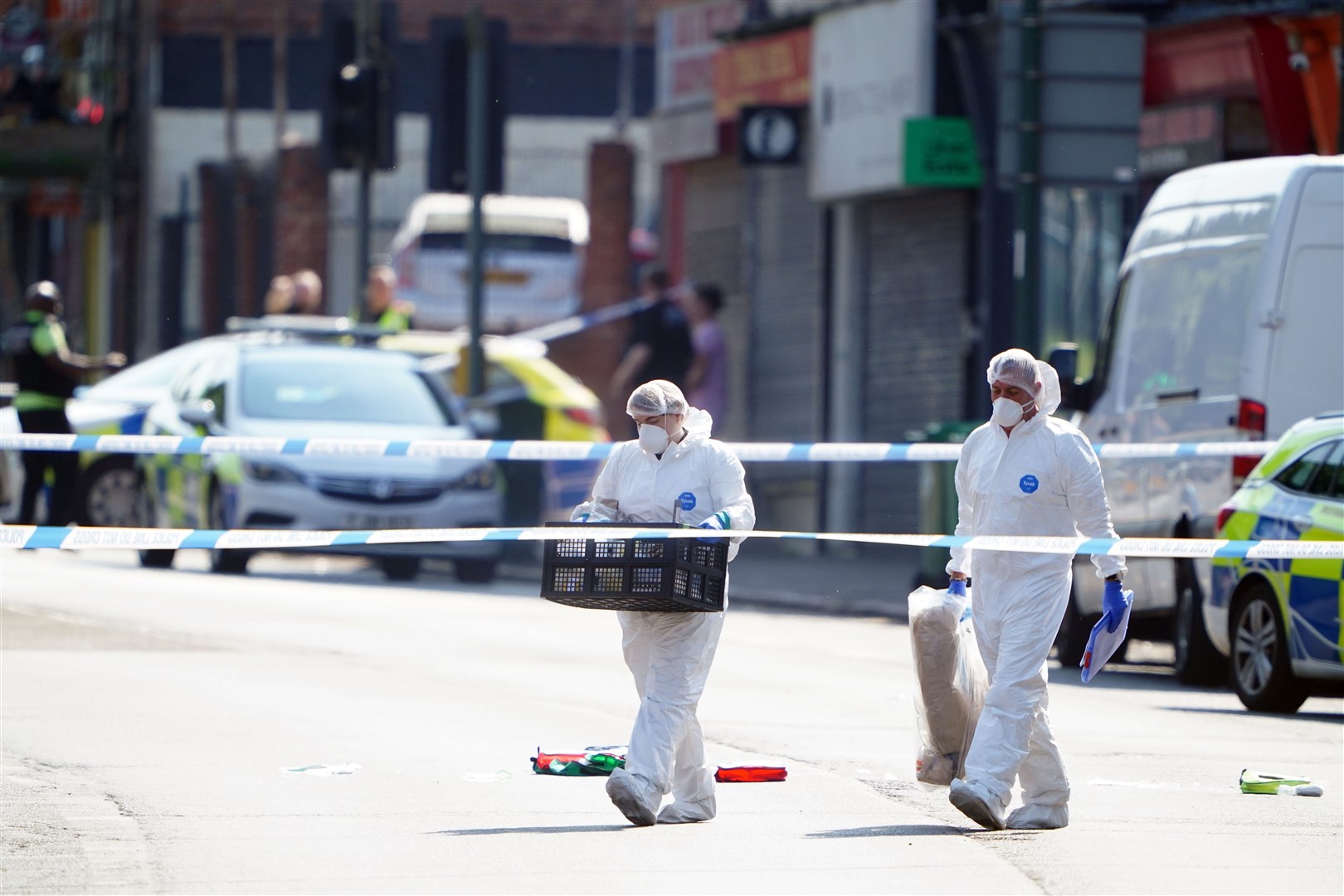 Police forensics officers on Ilkeston Road, Nottingham, where two university students were killed (Zac Goodwin/PA)