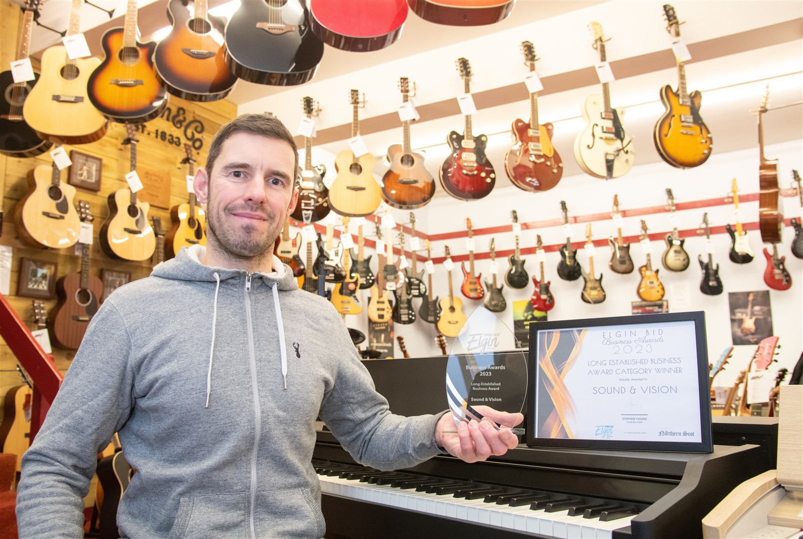 Graham Flett works at Sound & Vision with hid dad Vic. The music shop won the long-established business award. Picture: Daniel Forsyth.