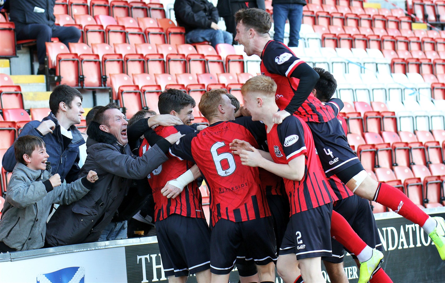 Elgin players and fans celebrate Kane Hester's goal in their fourth round Challenge Cup win at Airdrie. Photo: Bob Crombie