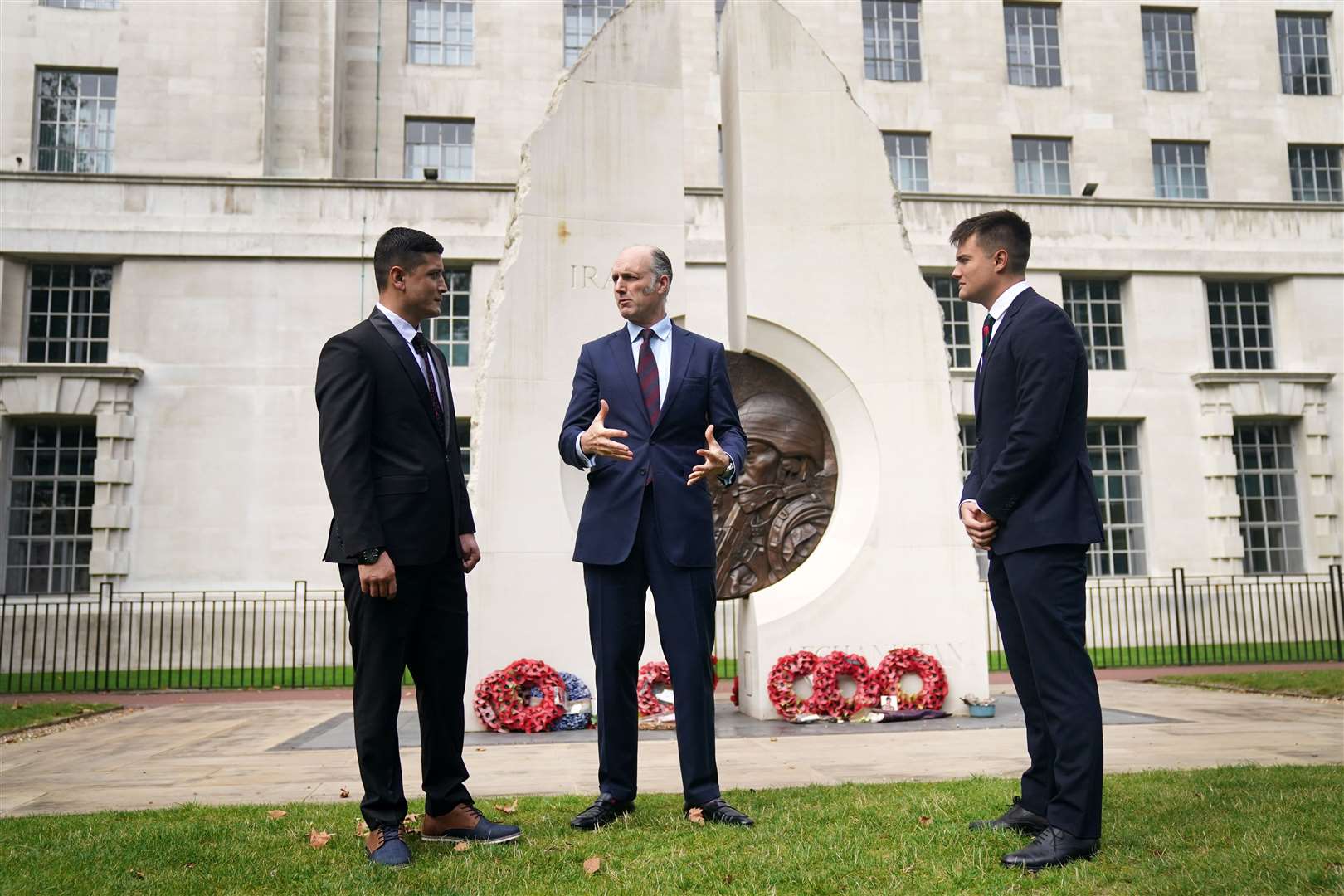 First Lieutenant Mohammad Jawad Akbari, veterans minister Leo Docherty and Captain Dave Kellett by the Iraq Afghanistan Memorial (Victoria Jones/PA)