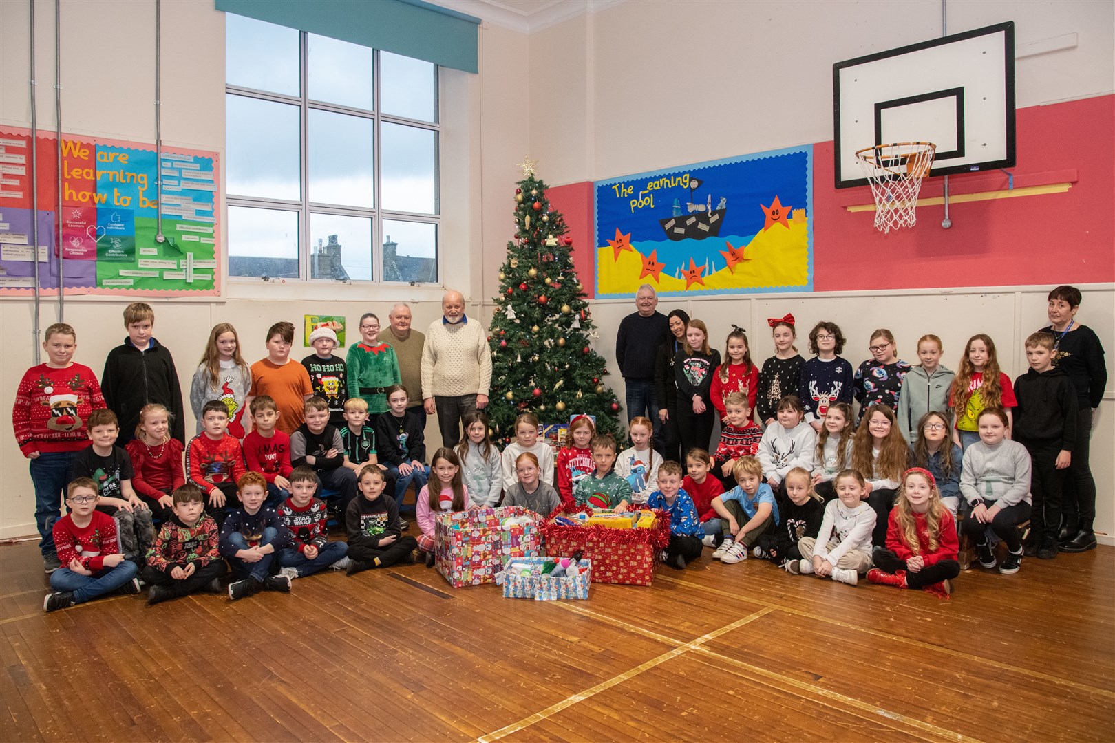 Cluny Primary pupils hand over the goods collected via their reverse Advent calendar to Hub volunteers. Picture: Daniel Forsyth