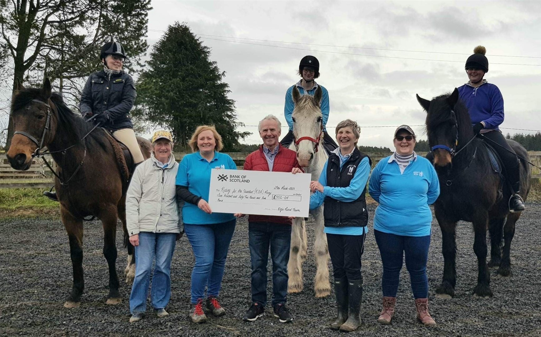 Riding for the Disabled are presented with a cheque for £552 by Elgin Musical Theatre's chairperson Ron Duncan.