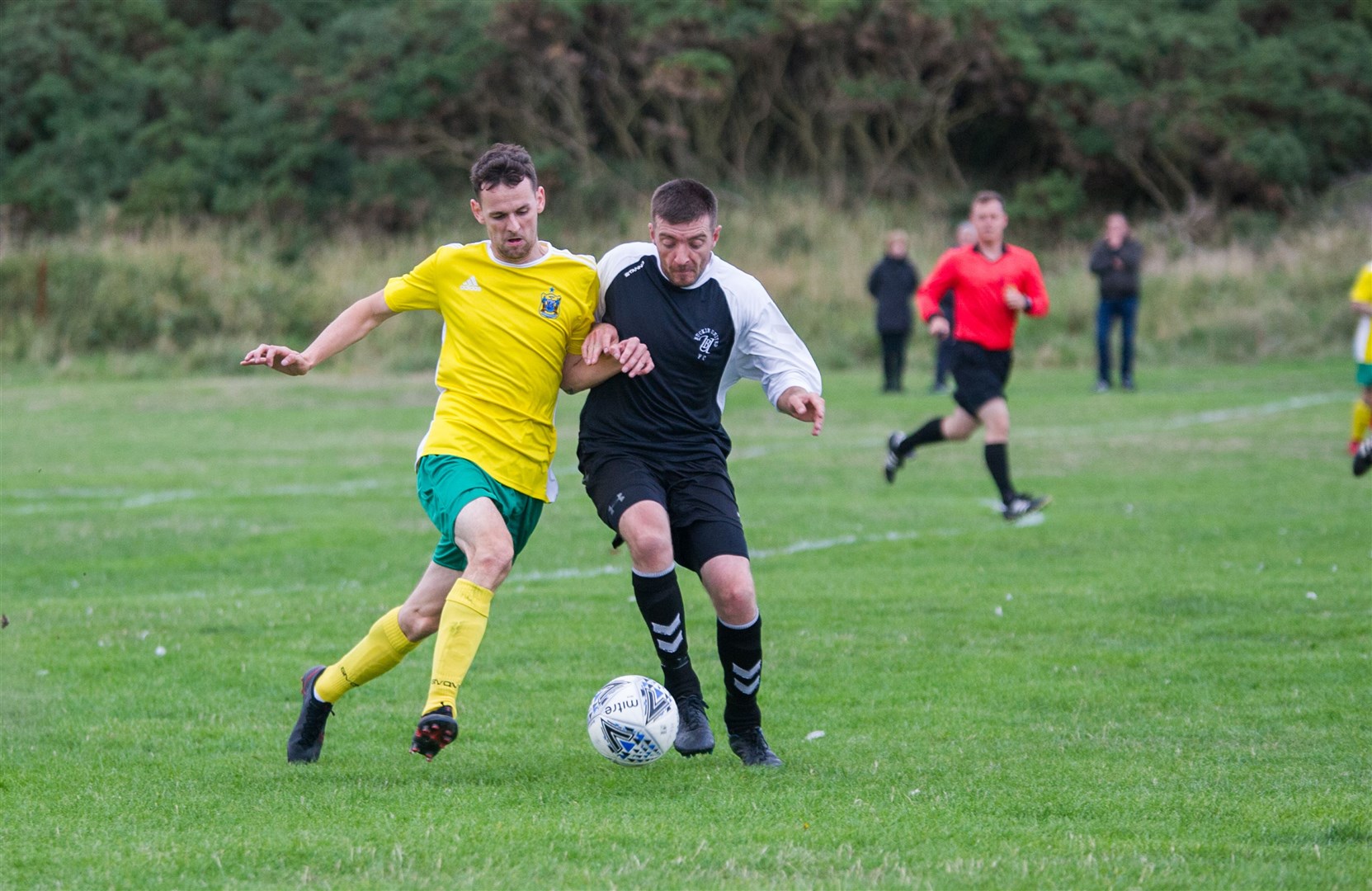 Hopeman's Ryan Farquhar and Buckie's Darren Thain press for the ball furing Friday's Moray welfare league match. Picture: Becky Saunderson..