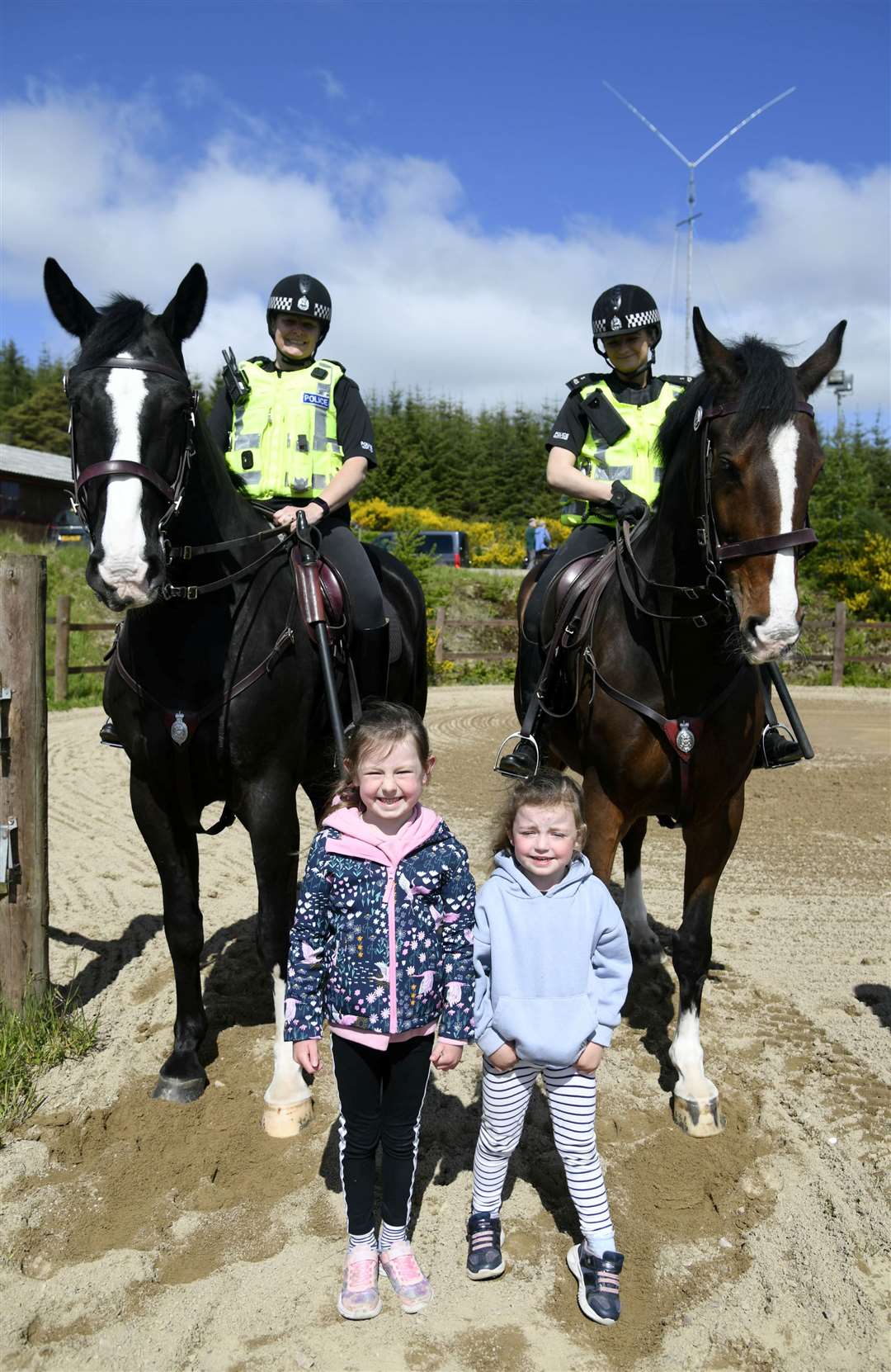 Isla Middleton (L) and Millie Middleton (R) with PC Karen Graham on Elgin (left) and PC Cara Graham on Logie (right)...Touchdown memorial home for horses held a traditional kermis...Picture: Becky Saunderson..