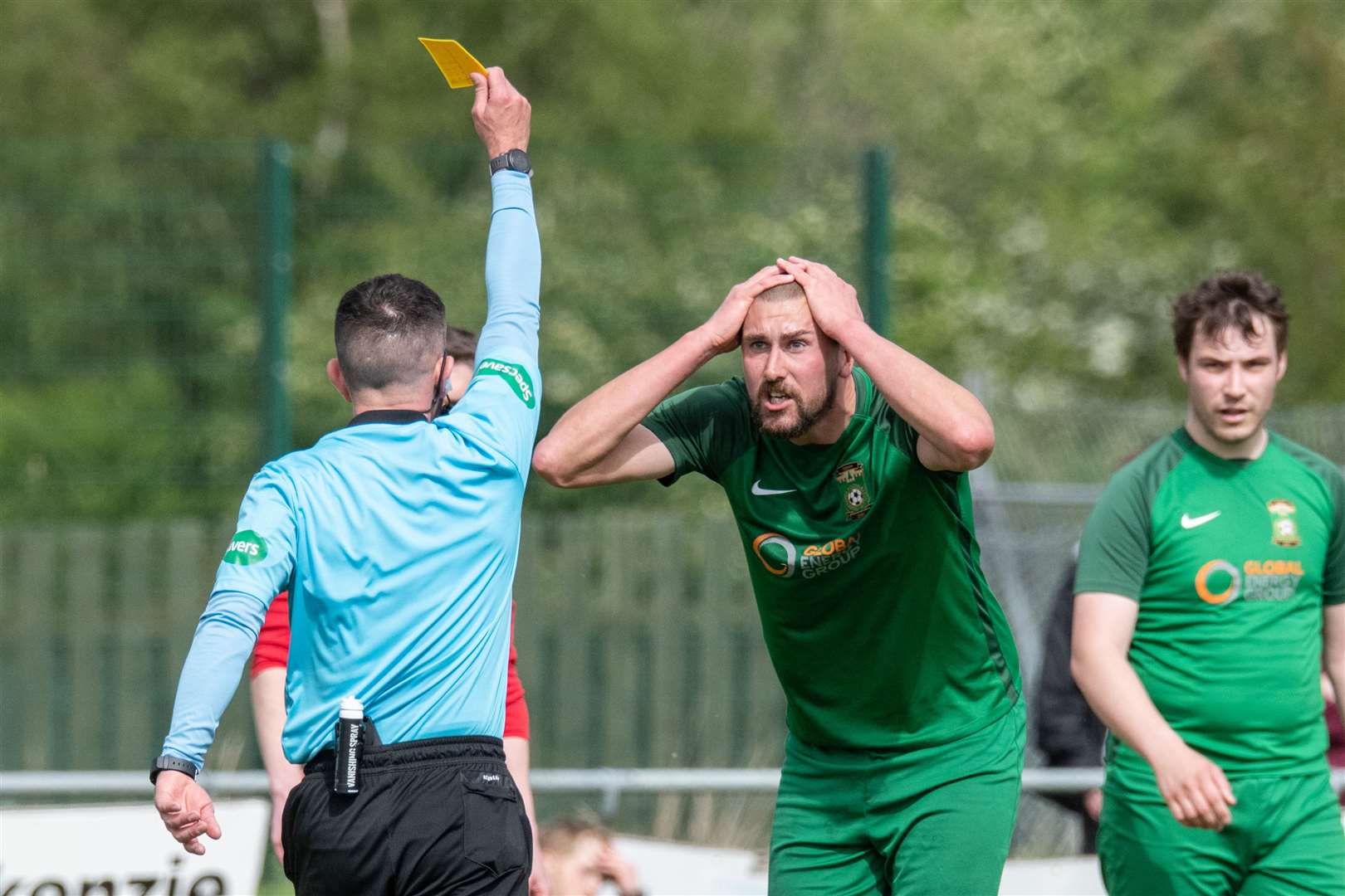 Michael Dunn cannot believe referee Kevin Buchanan's decision as he awards a free kick to Forres and books the Dufftown centre half. ..Dufftown FC (2) vs Forres Thistle FC (2) - Dufftown FC win 5-3 on penalties - Elginshire Cup Final held at Logie Park, Forres 14/05/2022...Picture: Daniel Forsyth..