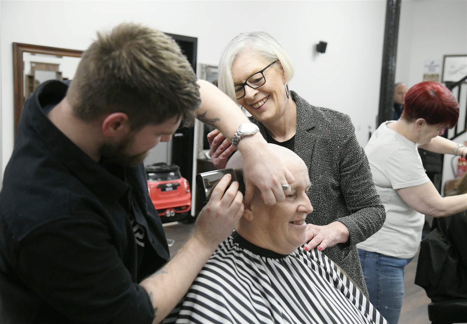 Linda Ogilvie during the final stage of her head shave done by Kate Cutajar and Brenden Bailey...K&M Barbers, Elgin...Picture: Beth Taylor.