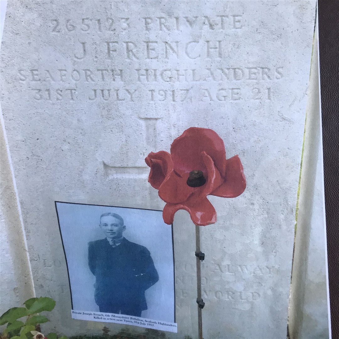 Joseph's grave with a poppy and his picture placed beside it.