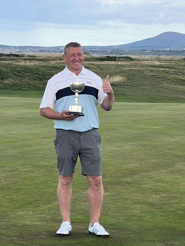 Gregor McLennan with his Section 1 trophy. Picture: Spey Bay GC