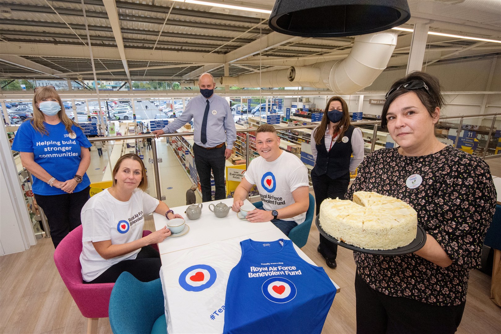 Tesco Elgin store manager Stephen McEwan (centre back) is joined by Tracy Gourlay (left), Susana Simoes (second right) and Tanya Harrison (right) along with the RAF's Pauline Evans and Thomas Lee on behalf of the Benevolent ahead of this weekend's Battle of Britain tea party in the cafe...Picture: Daniel Forsyth..