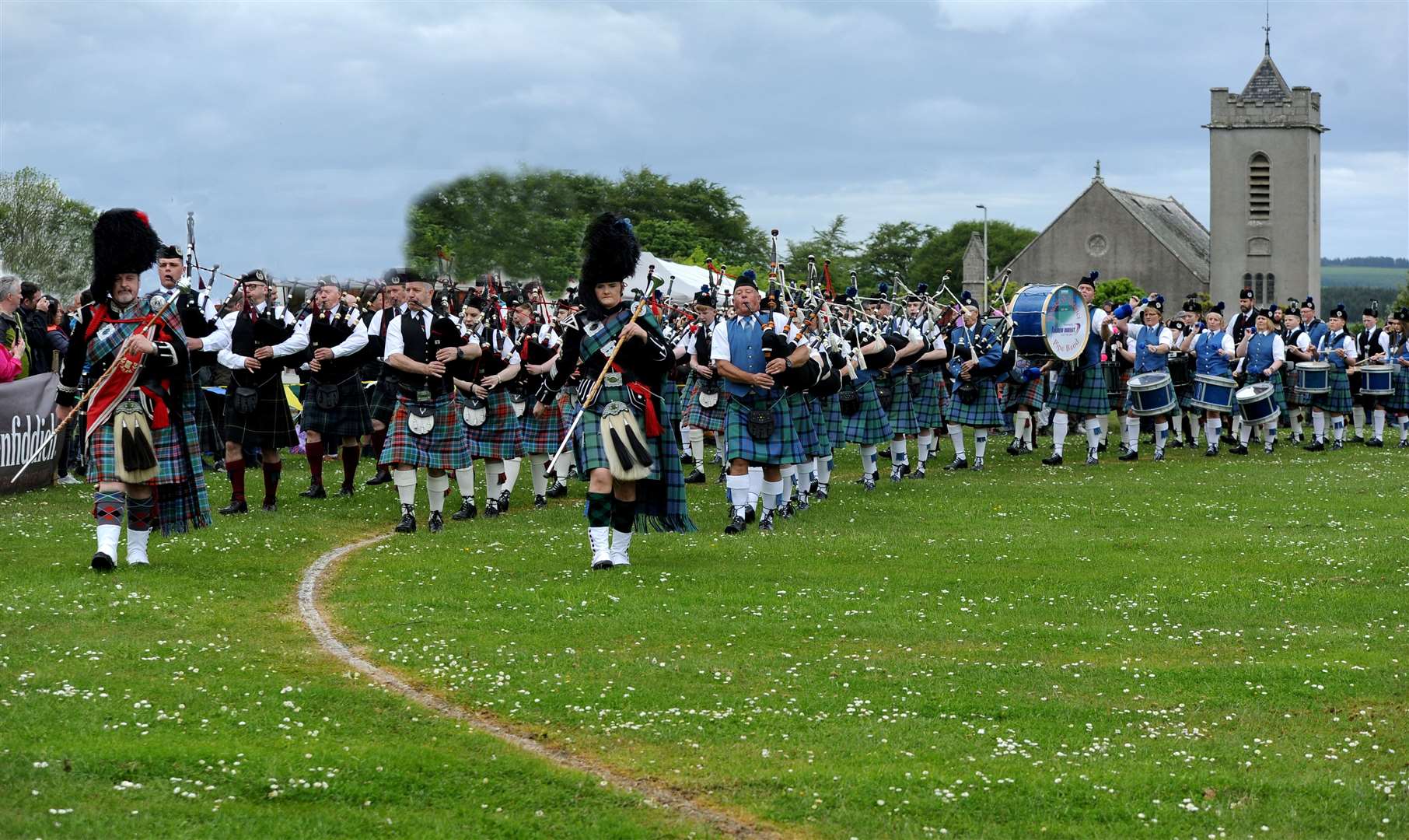 The massed pipe bands enter the arena at Cornhill. Picture: Eric Cormack