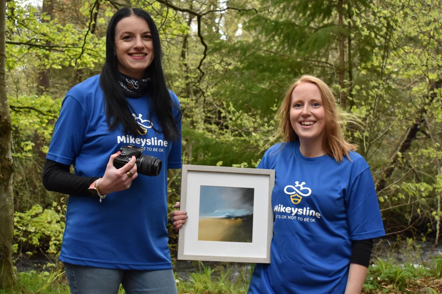 Mikeysline support worker Clare Gordon (left) and Highland artist Reina Edmiston with the prize for the competition winner.
