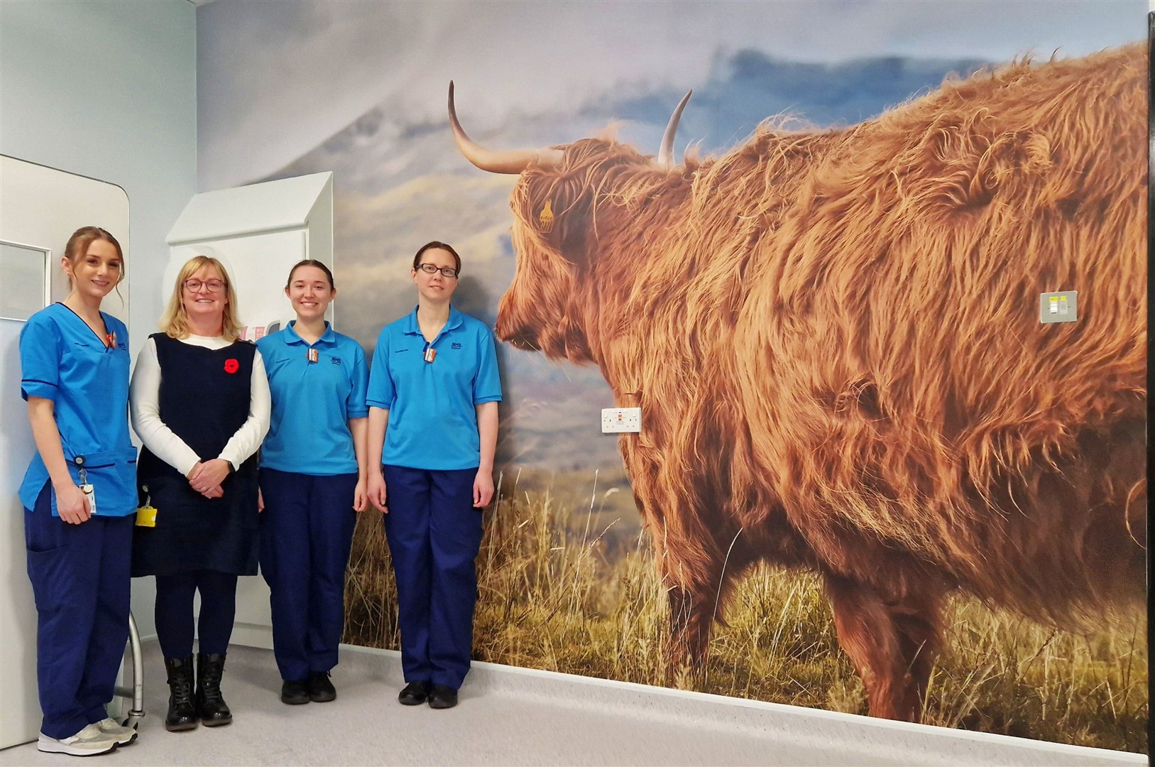 Enjoying the mural of the Highland cow, from left, Megan Mcgowan, (radiographer), Morag Howard (radiology site superintendent), Mhairi Maclean, (radiographer) and Laura Griffiths, (radiographer).