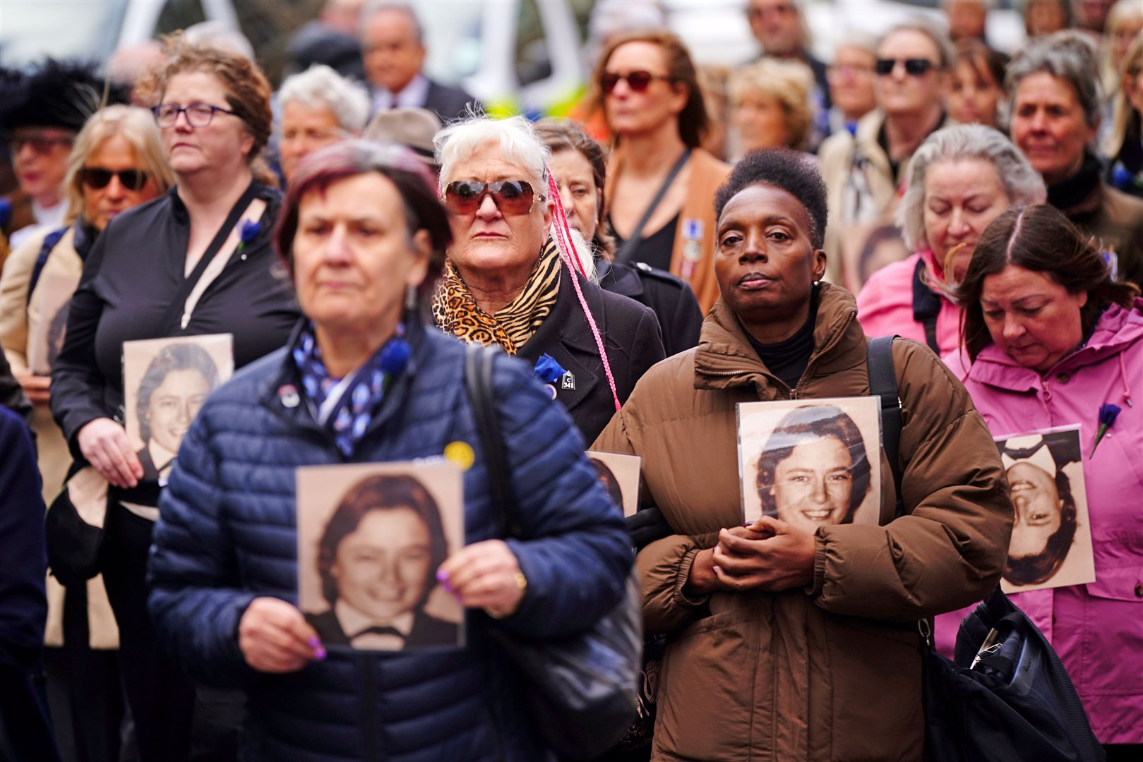 Colleagues of Pc Yvonne Fletcher hold photos of her during a procession around St James’s Square, London, ahead of the memorial service (Victoria Jones/PA)